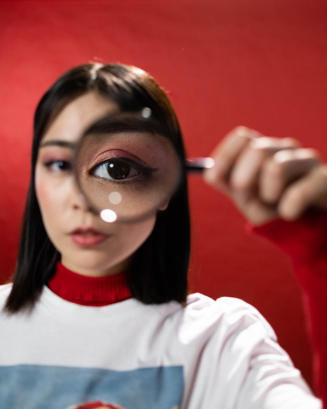 woman holding a magnifying glass